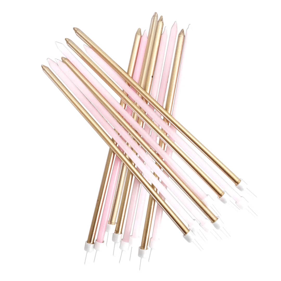 velas longas douradas e rosa